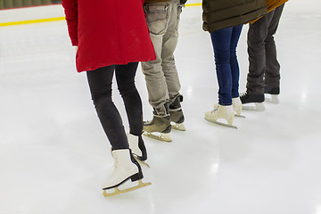 Image showing close up of friends on skating rink