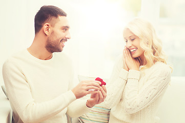 Image showing man giving woman engagement ring for christmas