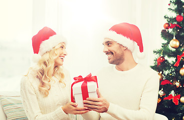 Image showing happy couple at home with christmas gift box