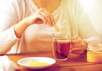 Image showing close up of ill woman drinking tea with ginger