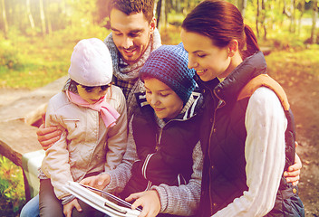 Image showing happy family with tablet pc and backpacks at camp