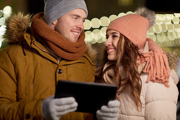 Image showing happy couple with tablet pc at christmas market