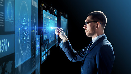 Image showing businessman in glasses with virtual projection