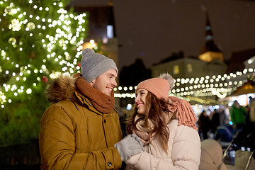 Image showing happy couple holding hands at christmas market