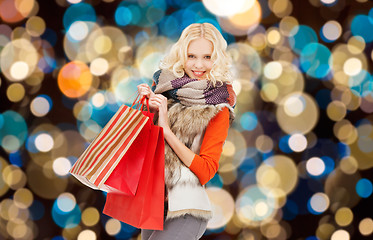 Image showing young woman in winter clothes with shopping bags