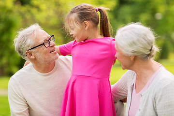 Image showing senior grandparents and granddaughter at park