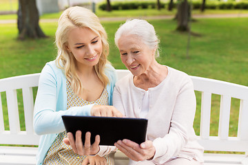 Image showing daughter with tablet pc and senior mother at park