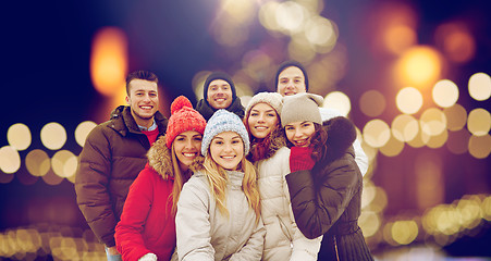 Image showing happy friends taking selfie outdoors at christmas