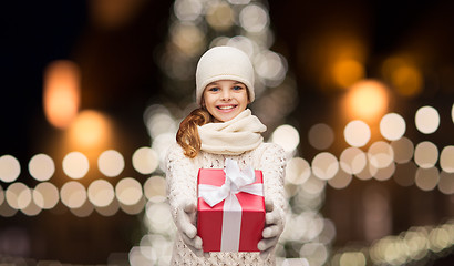 Image showing happy girl in winter clothes with gift box