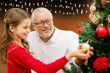 Image showing happy family decorating christmas tree