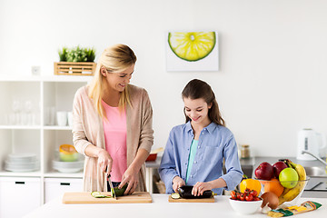 Image showing happy family cooking dinner at home kitchen