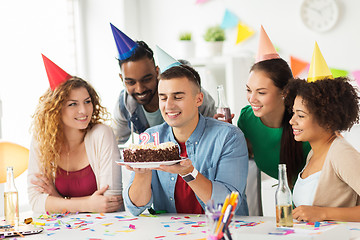 Image showing man with birthday cake and team at office party