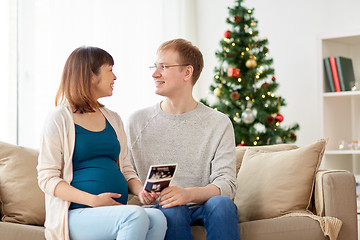 Image showing happy couple with ultrasound images at christmas