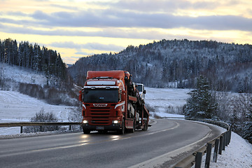 Image showing Car Carrier on Winter Road at Dusk