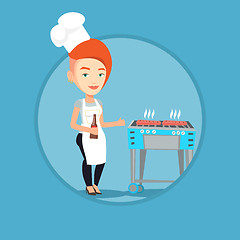 Image showing Woman cooking steak on barbecue grill.