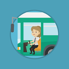 Image showing Caucasian bus driver sitting at steering wheel.