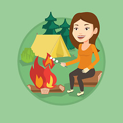 Image showing Woman roasting marshmallow over campfire.