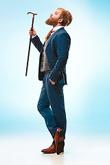 Image showing The barded man in a suit holding cane.