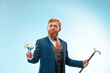 Image showing The barded man in a suit holding cane.