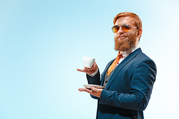 Image showing Portrait of a business man isolated on blue background.