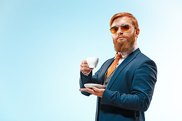 Image showing Portrait of a business man isolated on blue background.