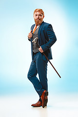 Image showing The barded man in a suit holding cane.