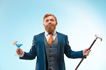 Image showing The barded man in a suit holding cane.