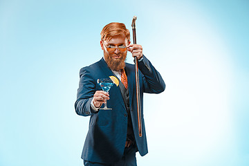 Image showing The barded man in a suit holding cane.