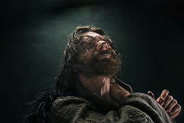 Image showing Portrait of a brutal bald-headed viking in a battle mail posing against a black background.