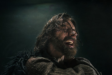 Image showing Portrait of a brutal bald-headed viking in a battle mail posing against a black background.