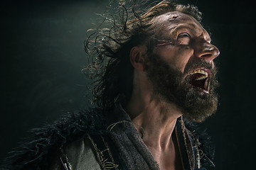 Image showing Portrait of a brutal bald-headed viking in a battle mail posing against a black background.