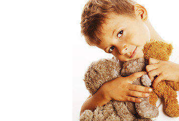 Image showing little cute boy with many teddy bears hugging isolated close up