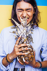 Image showing lifestyle people concept. young pretty smiling indian girl with pineapple, asian summer fruits 