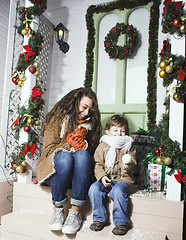 Image showing happy smiling family on Christmas at house with gifts, young mot