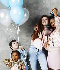 Image showing Lifestyle and people concept: young pretty diversity nations woman with different age children celebrating on birth day party together happy smiling, making selfie. African-american, asian and caucasi