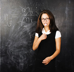 Image showing portrait of happy cute student in classroom at blackboard back t