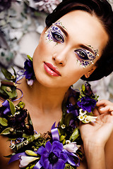 Image showing floral face art with anemone in jewelry, sensual young brunette 