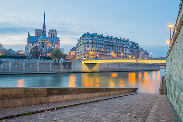 Image showing Notre Dame Cathedral with Paris cityscape at dus