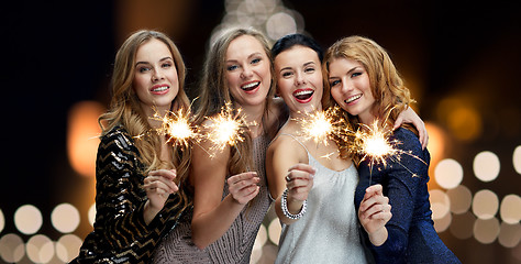 Image showing happy young women with sparklers at new year night