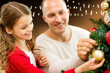 Image showing happy family decorating christmas tree at home