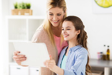 Image showing happy family with tablet pc computer at kitchen