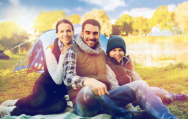 Image showing happy family with tent at camp site