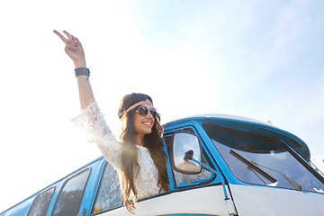 Image showing happy hippie woman showing peace in minivan car