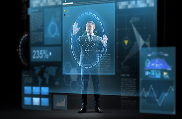 Image showing businessman in suit with virtual projection