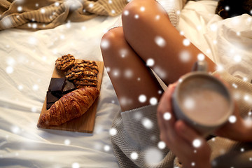 Image showing close up of woman with sweets and cocoa in bed