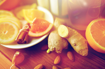 Image showing ginger, citrus fruits, tea or honey on wood