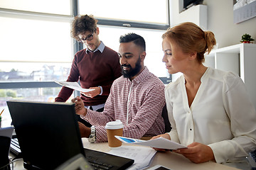 Image showing business team with laptop and coffee in office