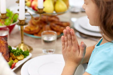 Image showing close up of girl having dinner and praying at home