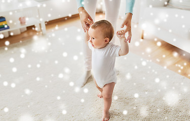 Image showing happy baby learning to walk with mother help