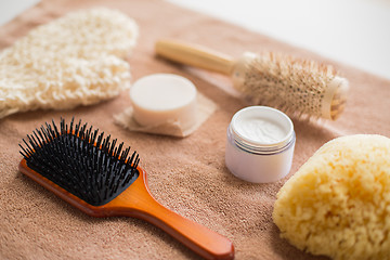 Image showing hair brush, cream, sponge, soap bar and bath towel